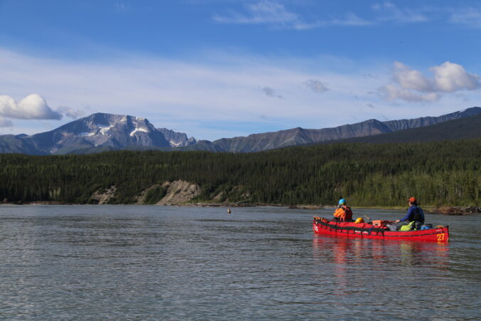 Looking at a mountain while paddling a canoe on the upper nahanni river